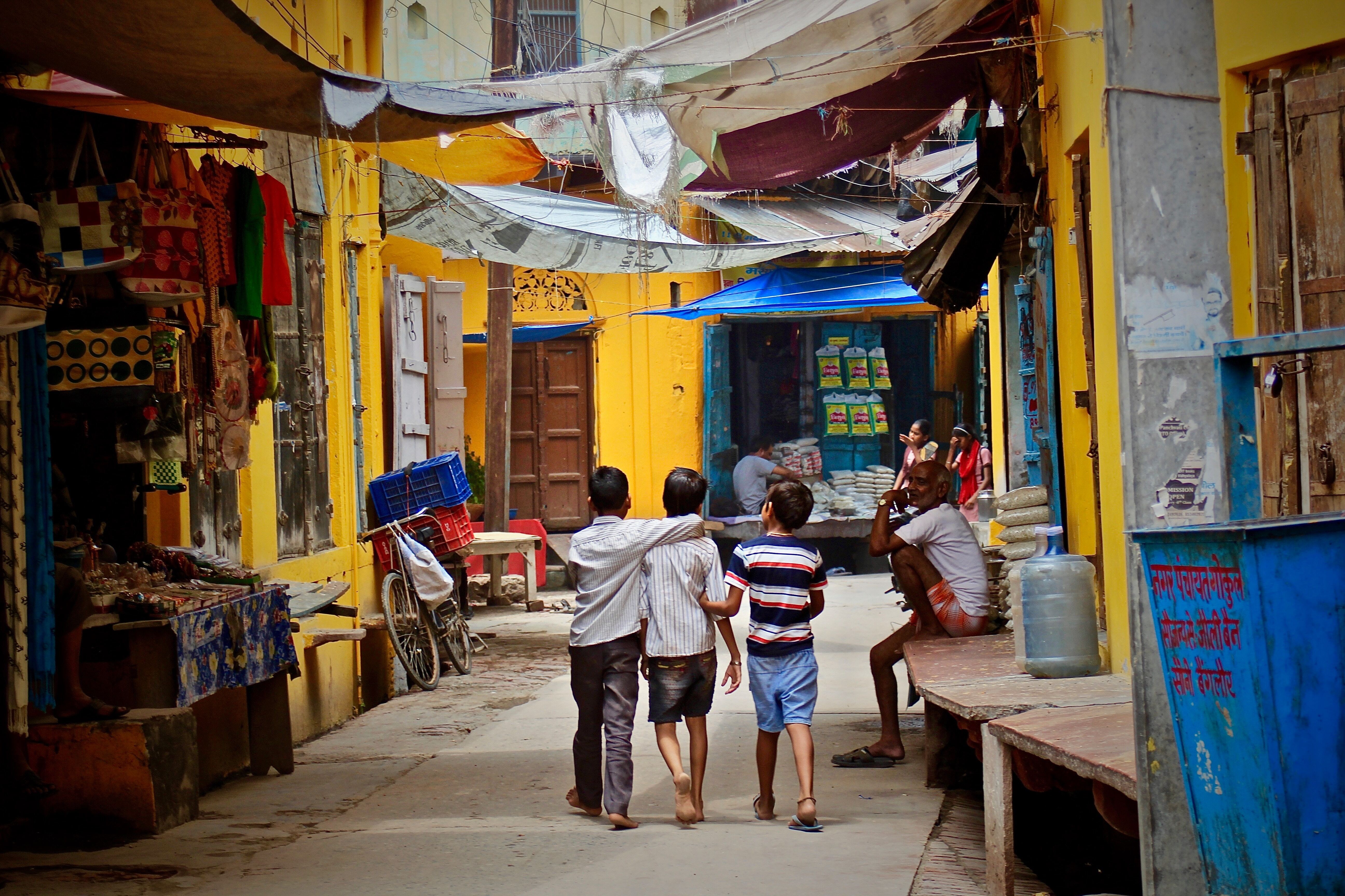 Children walking through a vibrant community street